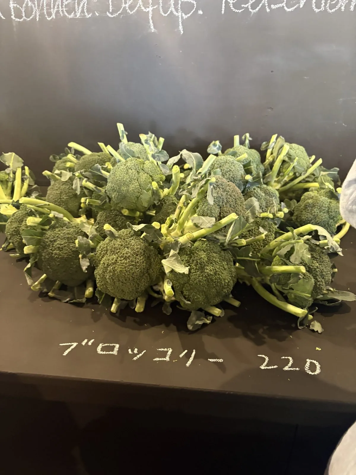 ブロッコリー220円。茎つきの新鮮なブロッコリーが山盛り